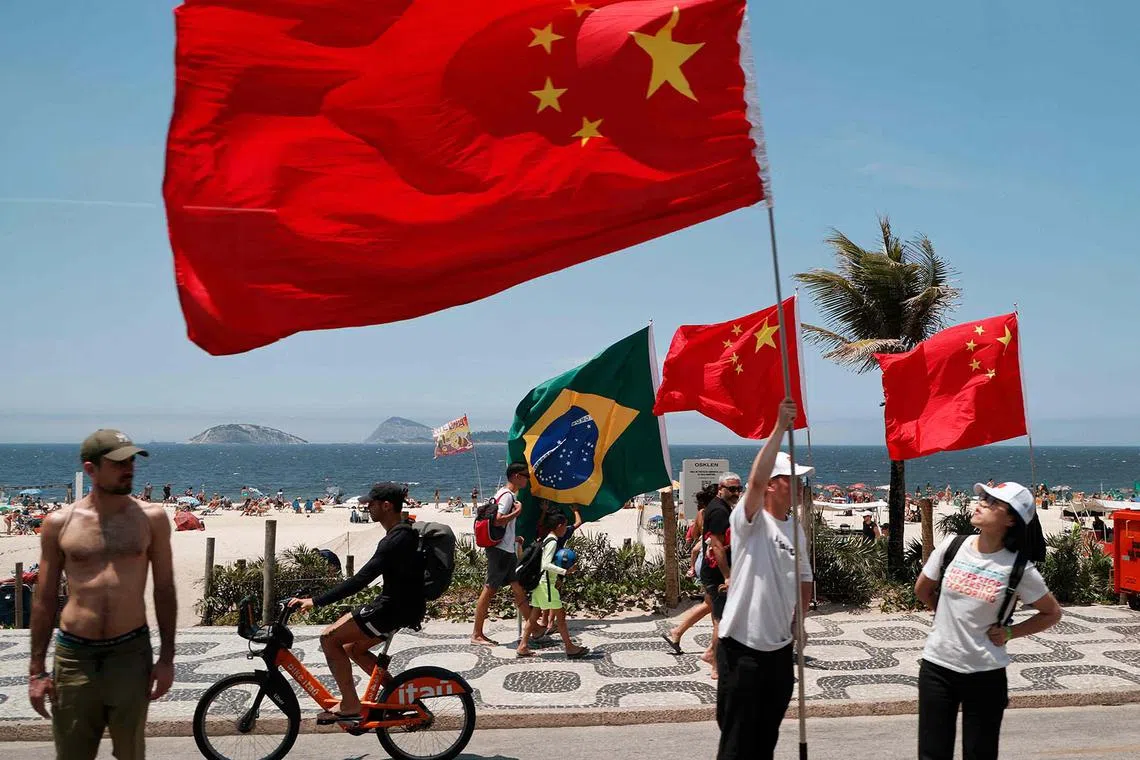 Chinese people waiting for President Xi Jinping's motorcade to pass by at Ipanema Beach during the G20 Leaders' Meeting in Rio de Janeiro, Brazil, on Nov 19, 2024. 