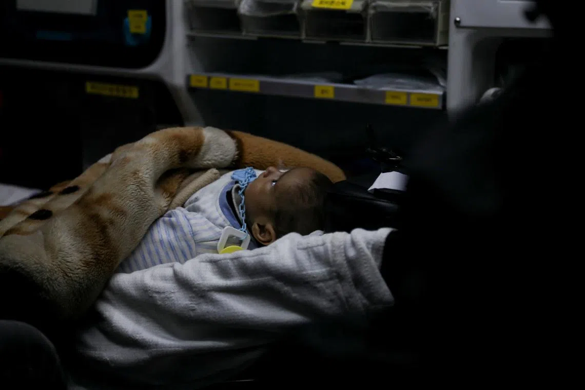 FILE PHOTO: A Palestinian child in need of medical treatment is evacuated through the King Hussein Bridge crossing, amid an impasse over the ceasefire deal between Israel and Hamas, in Jordan, March 4, 2025. REUTERS/Alaa Al Sukhni/File photo
