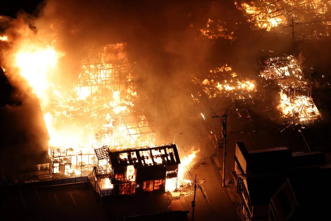 An aerial photo showing buildings burning in the city of Wajima, Ishikawa prefecture, on Jan 1, 2024, after a major 7.5 magnitude earthquake struck the Noto region in Ishikawa prefecture in the afternoon. 