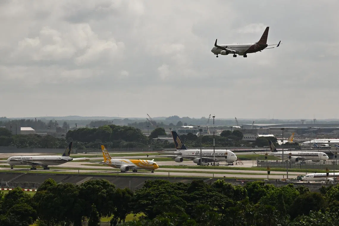 Singapore Airlines (SIA) and Scoot aeroplanes parked in airside at Changi Airport as viewed from Changi Business Park Vista on Mar 14, 2022.