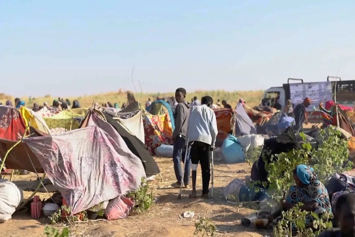 Displaced Sudanese gather and sit in makeshift tents after fleeing Al-Fashir city in Darfur, in Tawila, Sudan, on Oct 29.