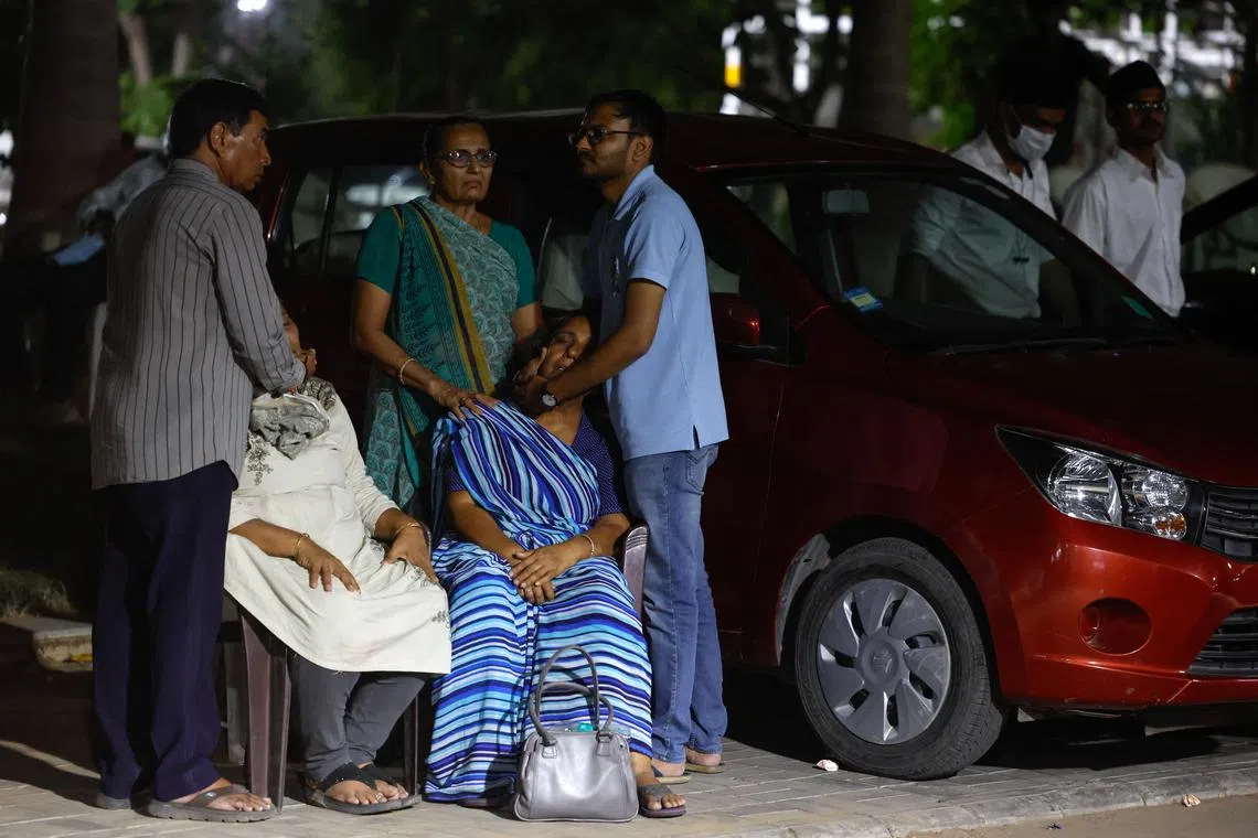 Relatives comforting parents of Arjun Patoliya, 37, who died when an Air India Boeing 787-8 Dreamliner plane crashed in Ahmedabad, India, on June 12, 2025. 