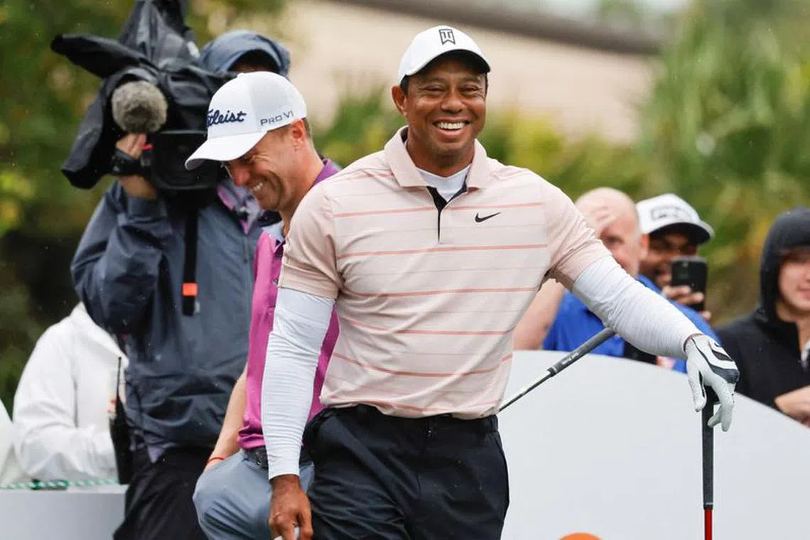 FILE PHOTO: Dec 16, 2023; Orlando, Florida, USA; Tiger Woods laughs at a comment made by playing competitor Justin Thomas (back) on the sixth tee box during the PNC Championship at The Ritz-Carlton Golf Club. Mandatory Credit: Reinhold Matay-USA TODAY Sports/File Photo