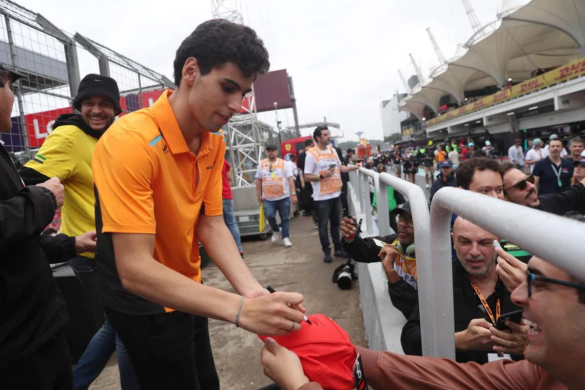 Gabriel Bortoleto signs autographs for fans at the Sao Paulo Grand Prix.