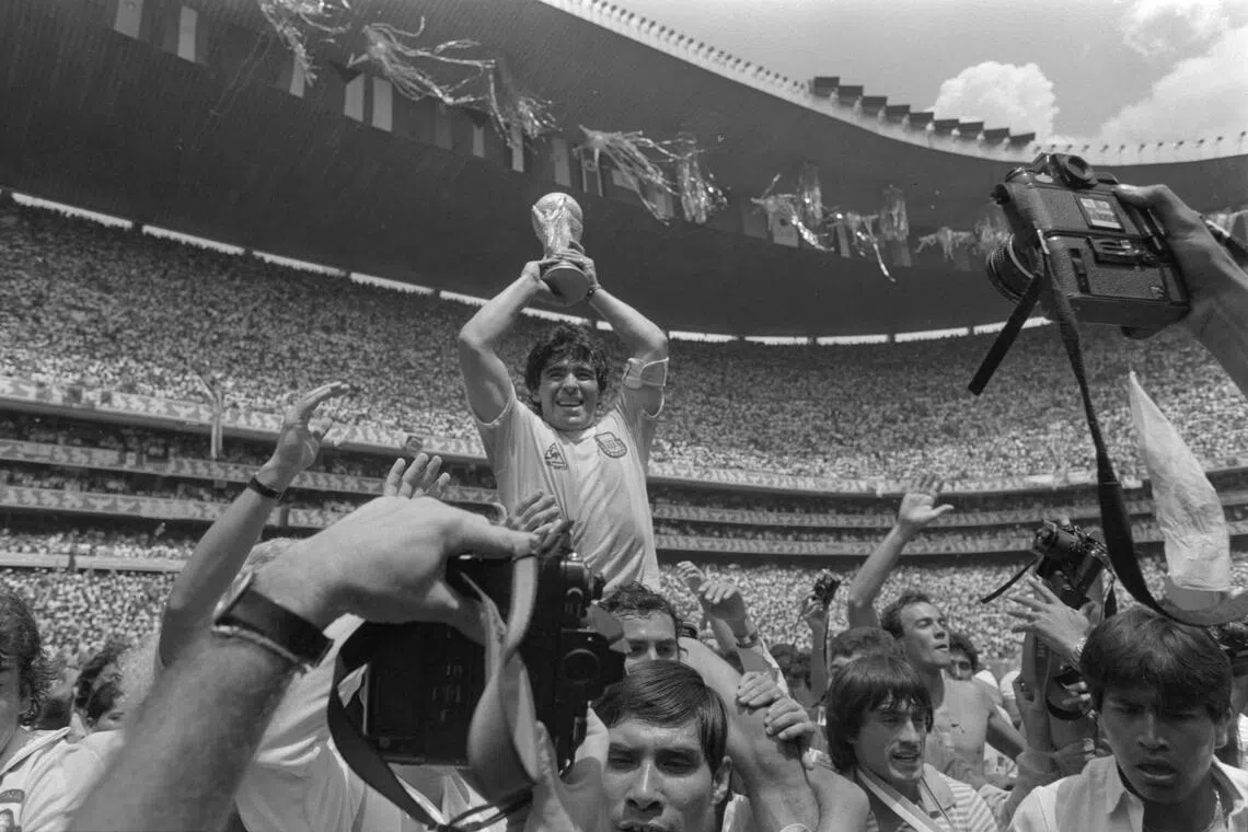 Diego Maradona celebrating with the World Cup trophy after Argentina won the final against West Germany at the Estadio Azteca in Mexico in 1986.