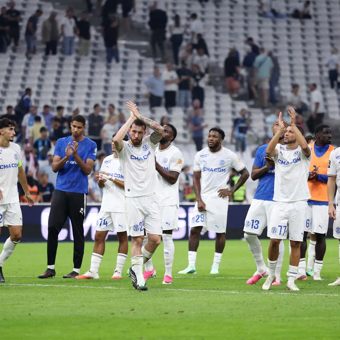 Soccer Football - Ligue 1 - Olympique de Marseille v Paris St Germain - Orange Velodrome, Marseille, France - September 20, 2026 Olympique de Marseille's Pierre-Emile Hojbjerg with teammates look dejected after the match REUTERS/Alexandre Dimou
