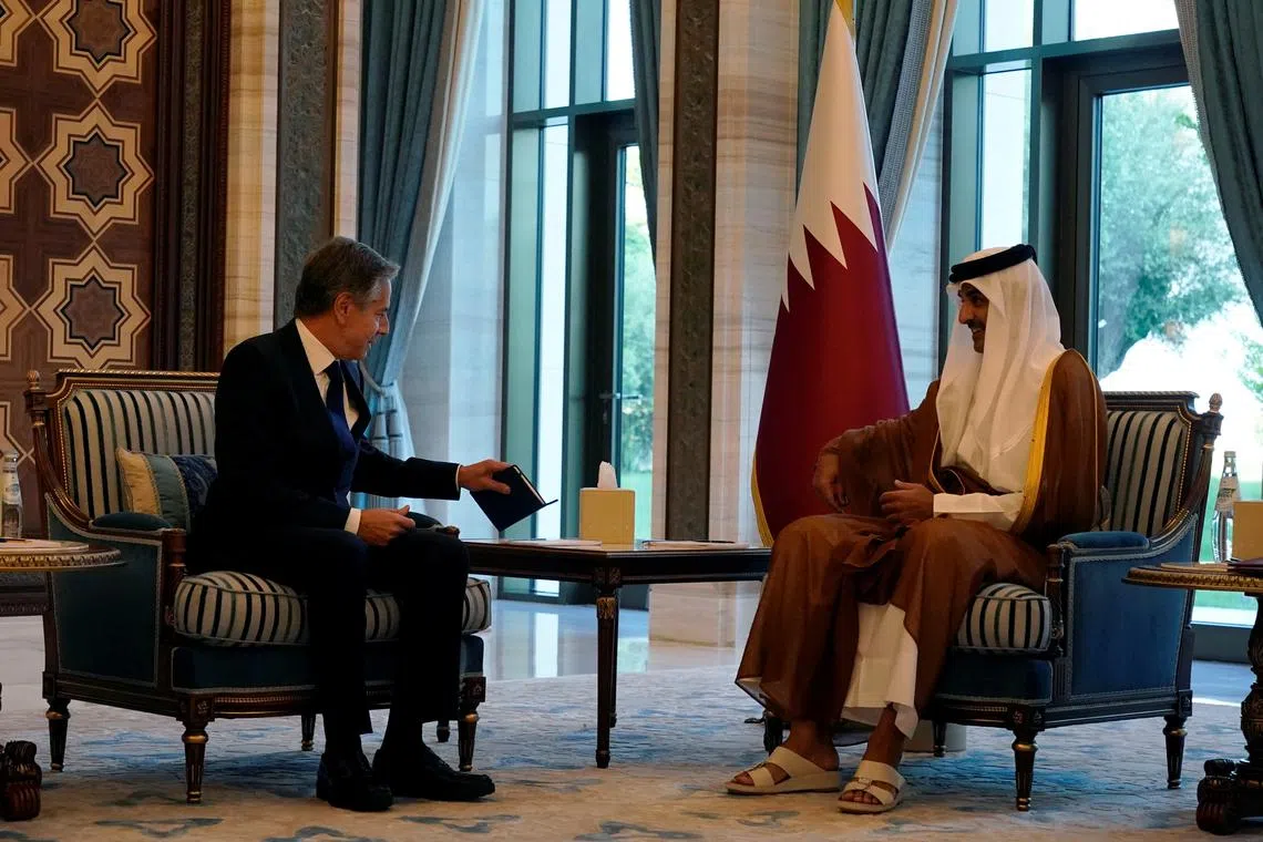 US Secretary of State Antony Blinken (left) and Qatari Emir Sheikh Tamim bin Hamad Al Thani at a meeting in Lusail, Qatar, on Oct 13.