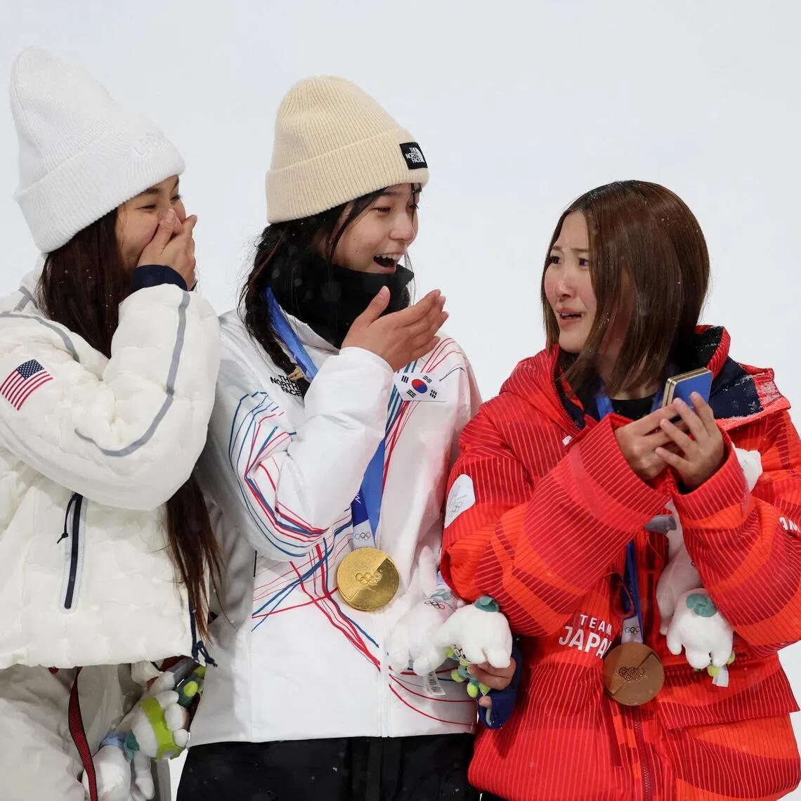 Gold medallist  Choi Ga-on of South Korea with silver medallist Chloe Kim of United States and Mitsuki Ono of Japan celebrate on the podium during the victory ceremony for the women's snowboard halfpipe event on Feb 12. 