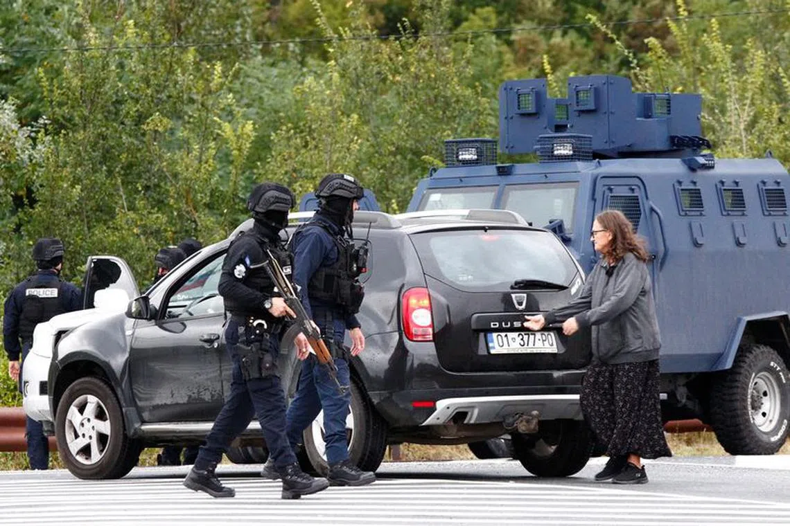 Kosovo police officers stand guard on the road to Banjska monastery, in the aftermath of a shooting incident, near Zvecan, Kosovo September 25, 2023. REUTERS/Ognen Teofilovski
