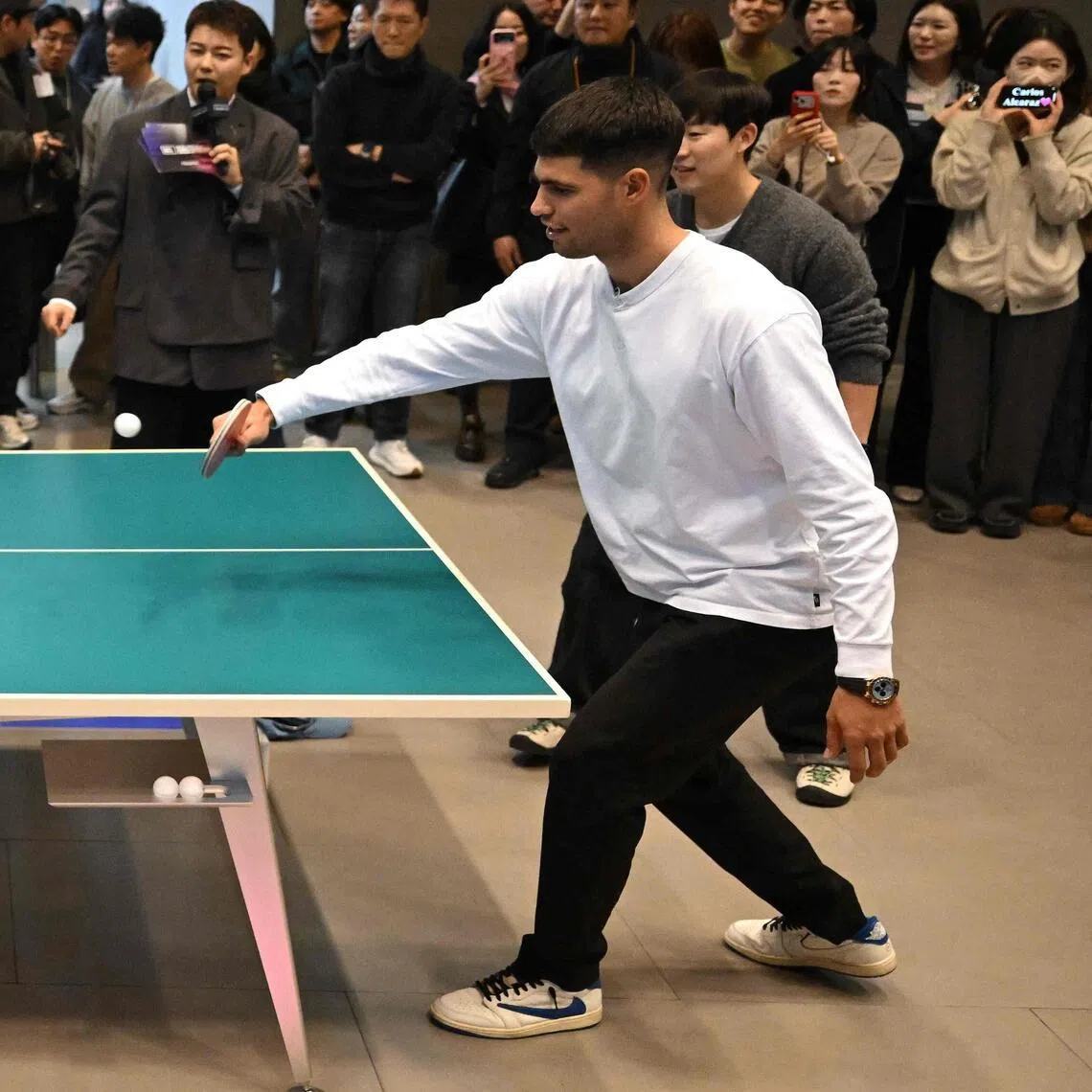 Italy's Jannik Sinner (left) playing table tennis with Spain's Carlos Alcaraz during a welcome event in Seoul on Jan 9 for their tennis exhibition match the following day.
