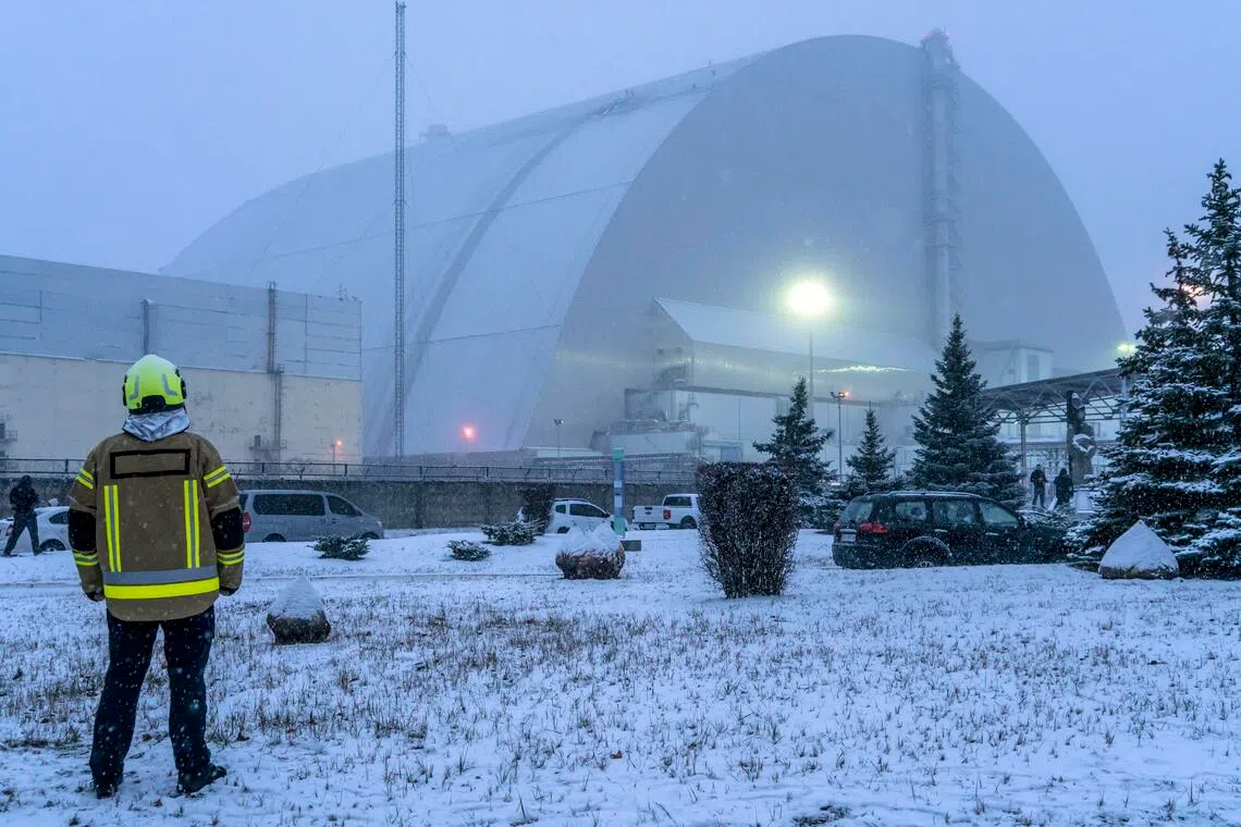 Officials inspecting damage to the radiation shield over Reactor No. 4 at the former Chernobyl nuclear power plant in Ukraine, in February 2025, after a Russian drone attack.