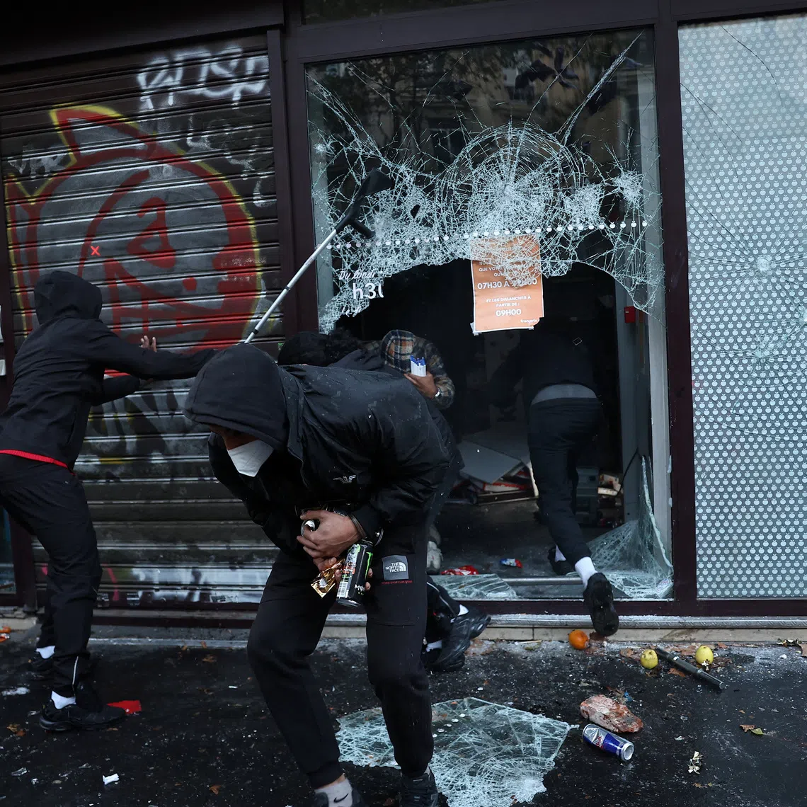Protesters loot a supermarket amid clashes during a day of demonstrations against the cost of living in France, on Oct 17.