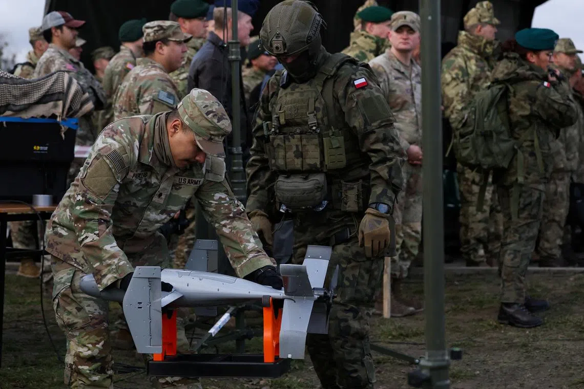 A U.S. soldier handles an AS3 interceptor, part of a modular American-made AI-powered counter-drone system MEROPS, during a presentation at a polygon in Nowa Deba, Poland, November 18, 2025. REUTERS/Kacper Pempel