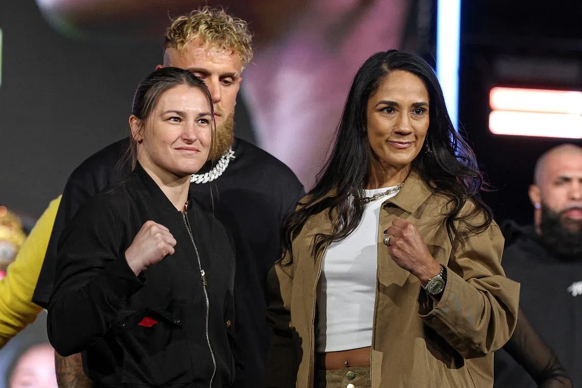 FILE PHOTO: Apr 9, 2025; New York, New York, USA; Katie Taylor (left) and Amanda Serrano (right) pose in front of Jake Paul during a press conference ahead of their boxing match at Madison Square Garden. Mandatory Credit: Vincent Carchietta-Imagn Images/File Photo