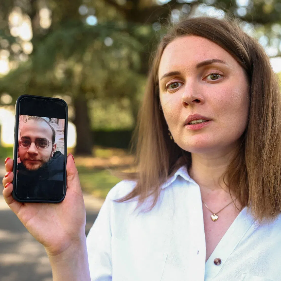 Belarussian journalist Katsyaryna Andreyeva shows a picture of her husband Ihar Ilyash on her mobile device after an interview with Reuters at the United Nations in Geneva, Switzerland, June 29, 2026. REUTERS/Denis Balibouse