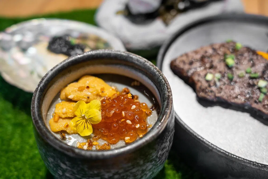 Dishes from The Social Outcast's omakase menu include chilled chawanmushi with smoked century egg topped with ikura and Japanese uni. 