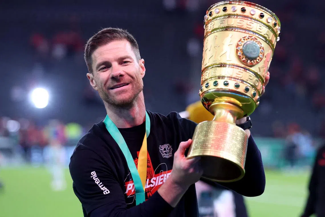 Soccer Football - DFB Cup - Final - 1.FC Kaiserslautern v Bayer Leverkusen - Olympiastadion, Berlin, Germany - May 25, 2024 Bayer Leverkusen coach Xabi Alonso celebrates with the trophy after winning the DFB Cup REUTERS/Thilo Schmuelgen