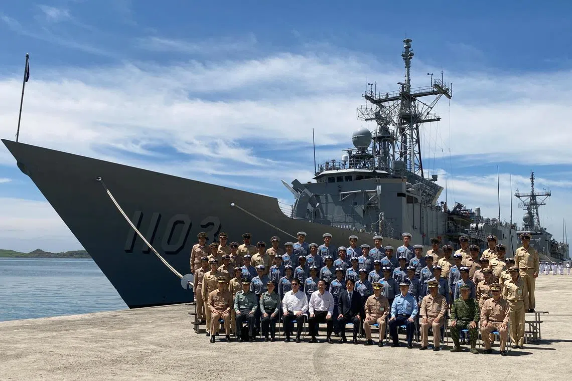 Taiwan's President Lai Ching-te (front in dark suit) poses for a group picture in front of the Taiwan warship Cheng Ho.