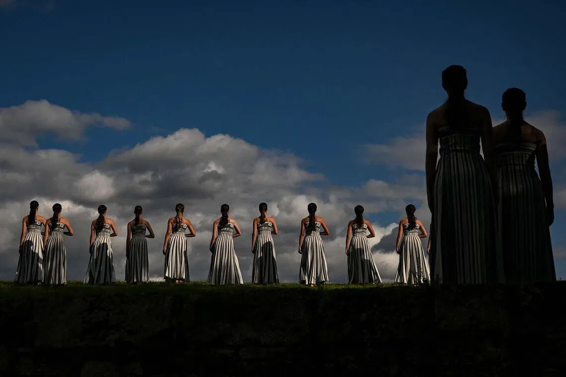 Actresses performing during a rehearsal of the lighting of the Olympic flame for the Milano-Cortina 2026 Winter Olympic Games, in the ancient Temple of Hera at the archaeological site of Olympia, the birthplace of the ancient Olympics in southern Greece, on Nov 24, 2025. 