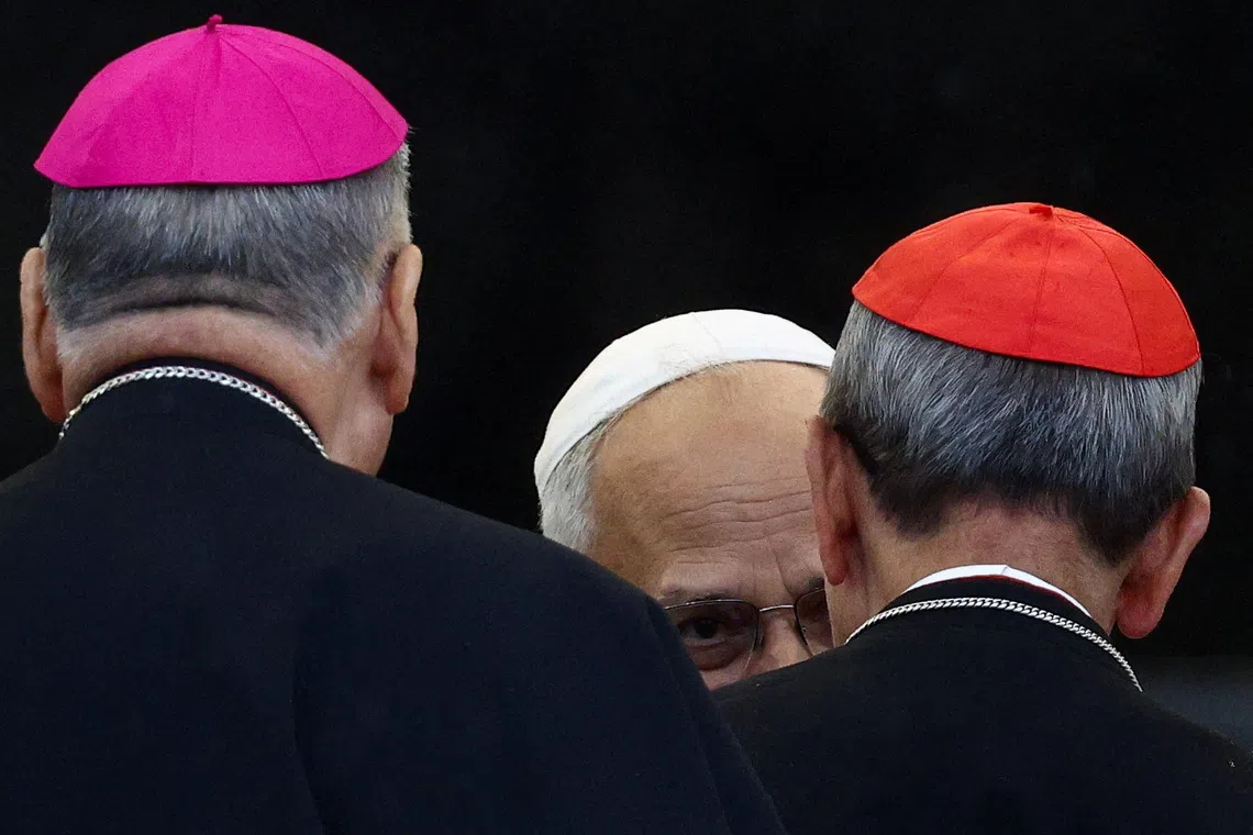 Pope Leo XIV greets a bishop and a cardinal, on the day he holds a general audience in St. Peter's Square at the Vatican, September 10, 2025. REUTERS/Guglielmo Mangiapane/File Photo