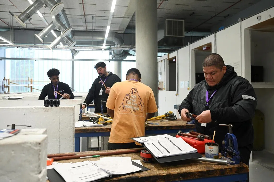 Plumbing students work during a plumbing class at City of Westminster College, Paddington, in London, Britain, on Nov 20.