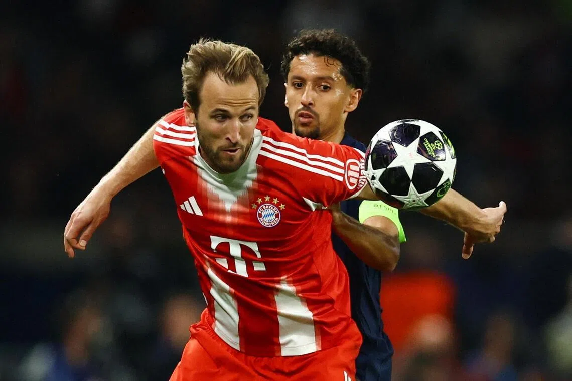 Bayern Munich's Harry Kane tussling with Paris Saint-Germain's Marquinhos during their Champions League semi-final clash.