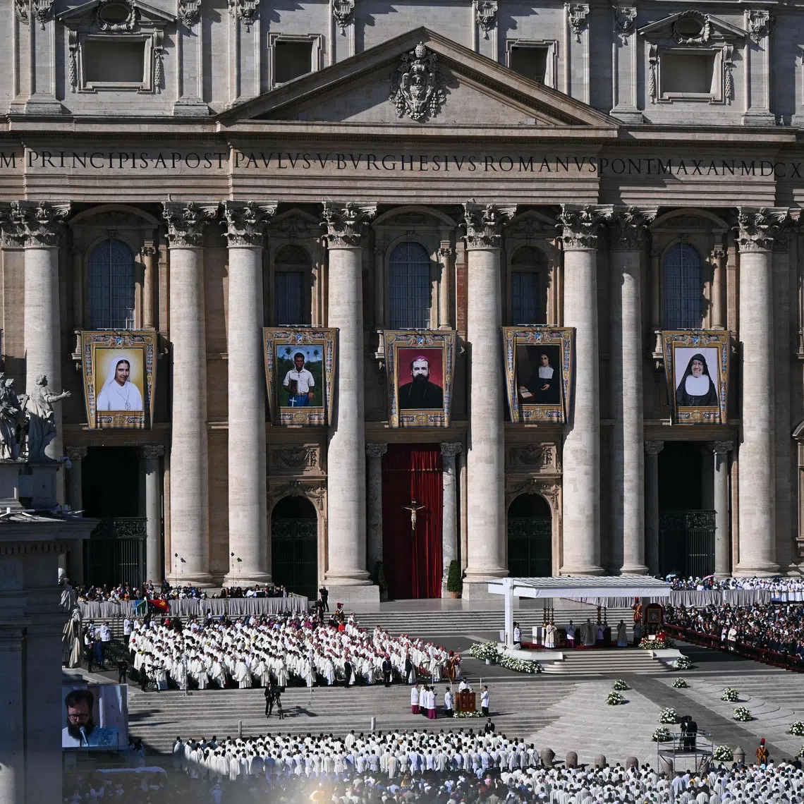 Portraits of the new saints are hung on St Peter's Basilica during a mass of canonisations in the Vatican on Oct 19.