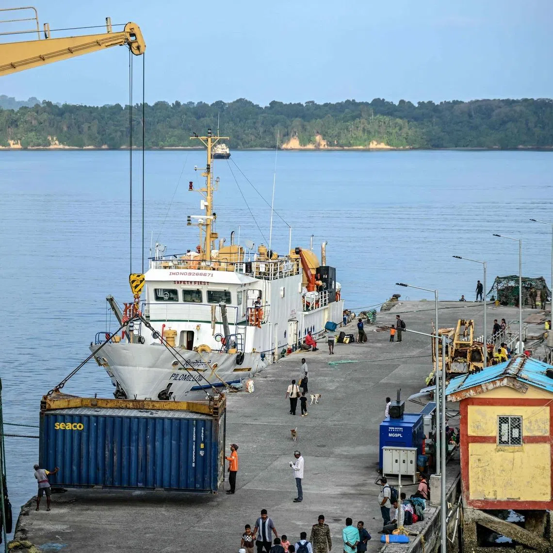 Workers unloading shipping containers from the Nalanda passenger vessel at Kamorta in India's Andaman and Nicobar Islands on March 25.