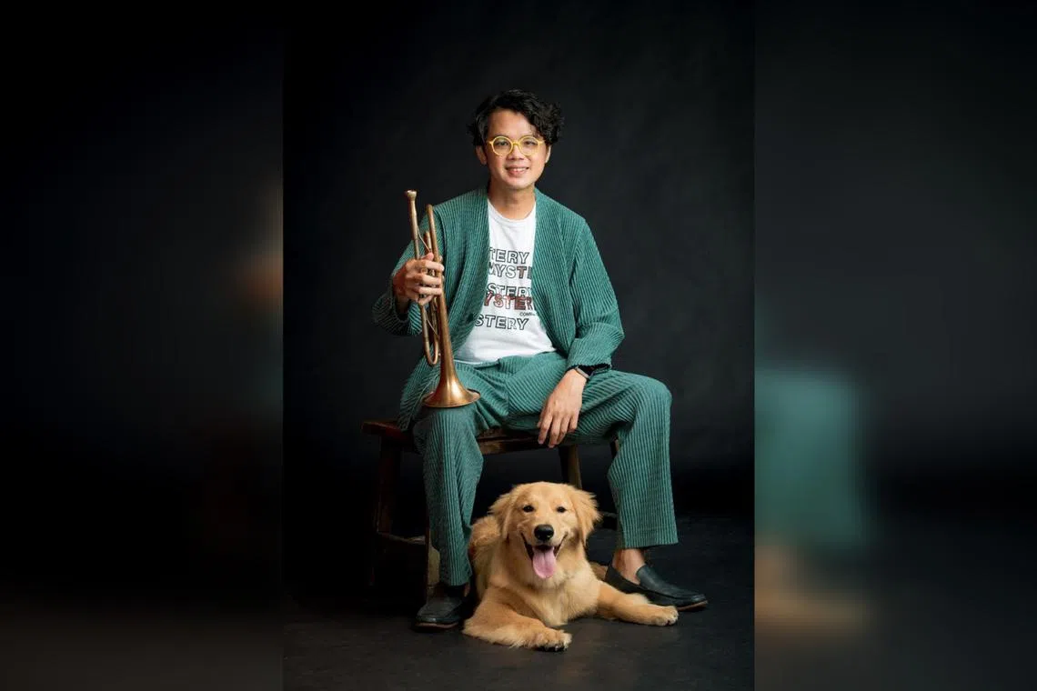 Singapore jazz musician and music director Weixiang Tan with his golden retriever, George.