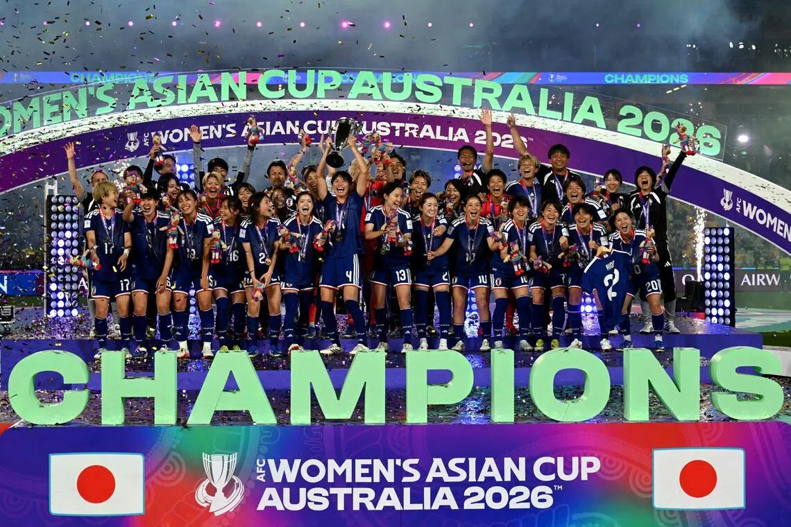 Japan's team celebrating with the trophy after beating hosts Australia 1-0 in the final of the 2026 Women’s Asian Cup at Stadium Australia in Sydney on March 21, 2026.
