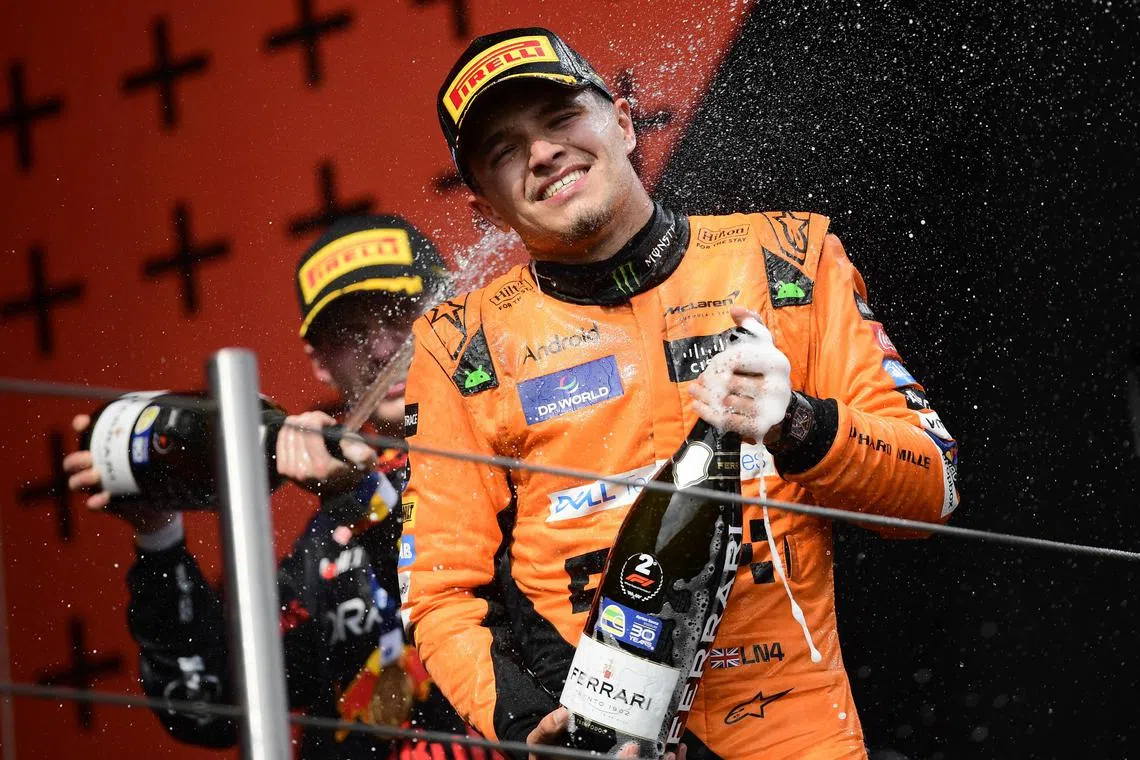 Red Bull's Max Verstappen spraying champagne on McLaren's second-placed Lando Norris after winning the Emilia Romagna Grand Prix on May 19.