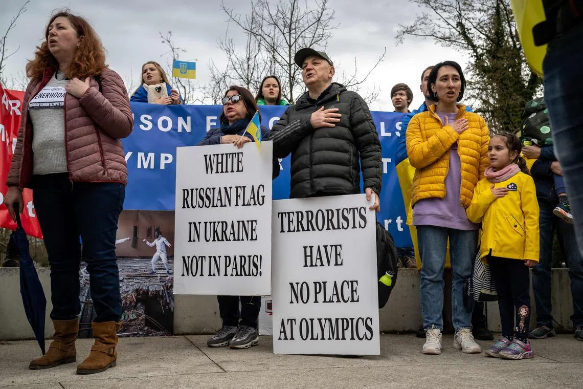 Ukrainians take part in a protest in front of the headquarters of the International Olympic Committee (IOC) against the return to competition of Russian athletes under a neutral flag.