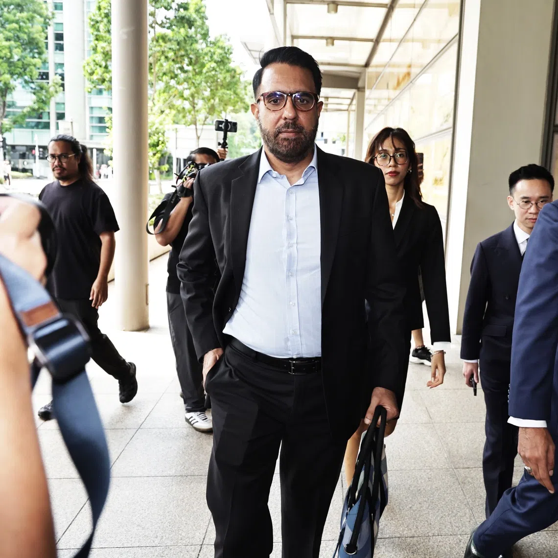 Workers' Party chief Pritam Singh (centre) returning to the High Court accompanied by lawyers Andre Darius Jumabhoy (right) and Aristotle Emmanuel Eng Zhen Yang (second fr right) on Nov 4.