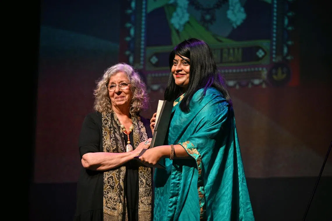 Prasanthi Ram, receiving her award from Meira Chand at Singapore Literature Prize Award Ceremony at Victoria Theater on Sep 10, 2024.