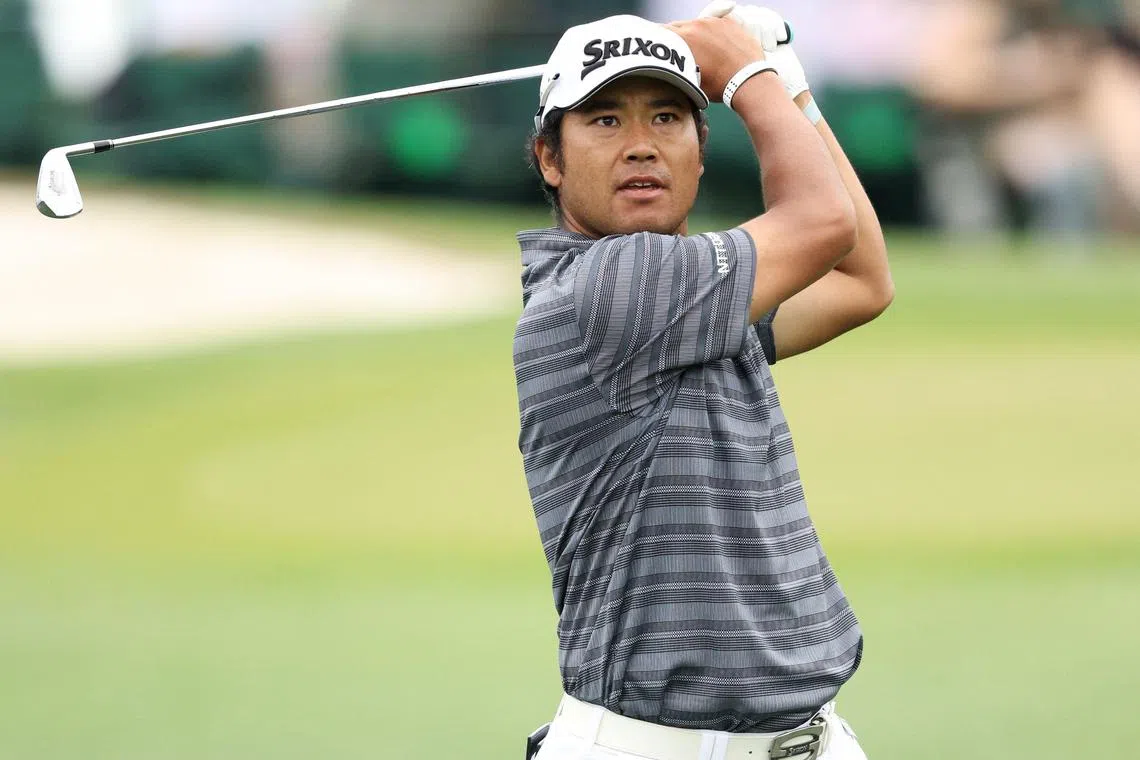 Hideki Matsuyama of Japan playing his shot on the third hole during a practice round prior to the 2024 Masters.