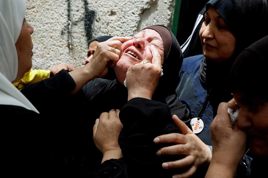 The mother of one of three Palestinian militants, who were killed in an Israeli raid, reacts during their funeral in Balata camp, Nablus, in the Israeli-occupied West Bank, May 22, 2023. REUTERS/Raneen Sawafta TPX IMAGES OF THE DAY