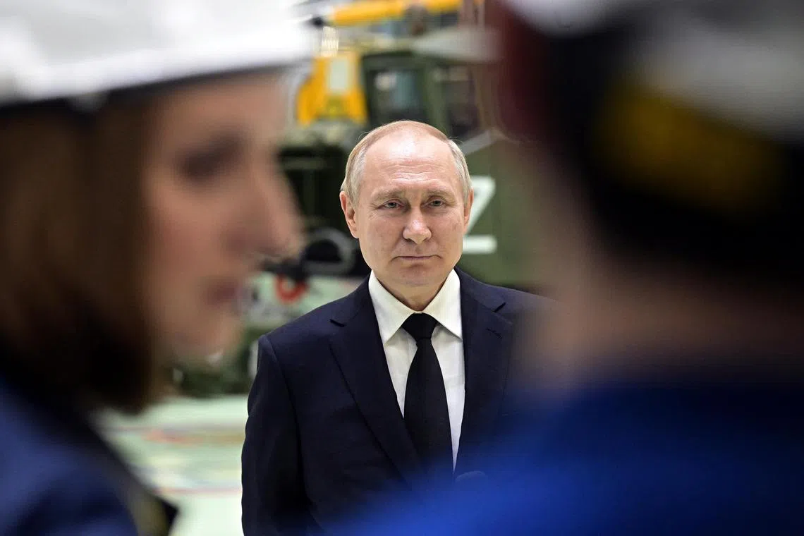 Russian President Vladimir Putin meets employees at a plant producing missiles, in Saint Petersburg, Russia, on Jan 18, 2023.