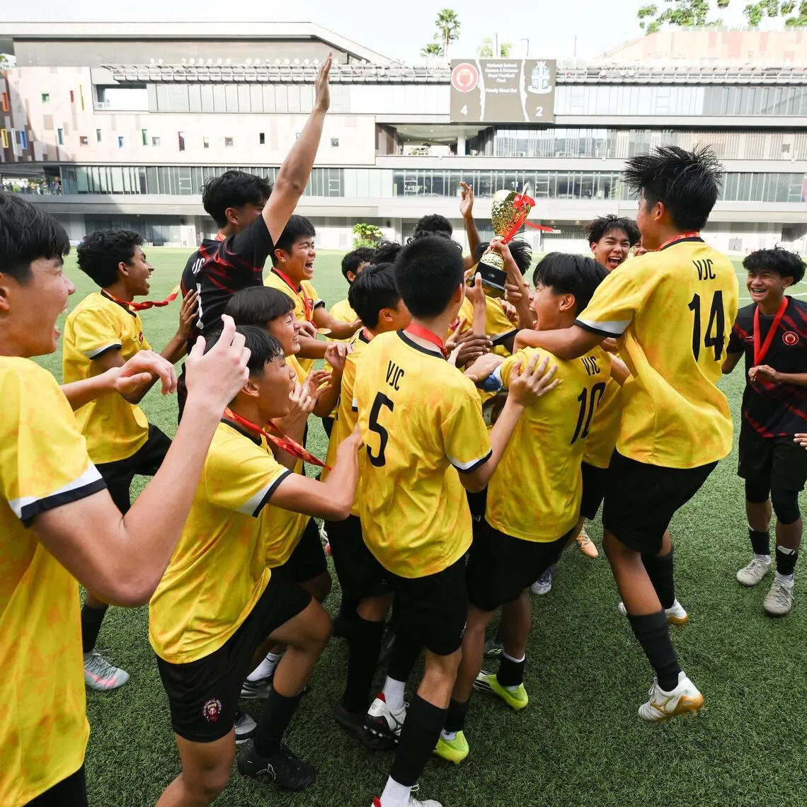 Victoria Junior College players celebrating with their trophy after winning A Division Boys' National School Games (NSG) football finals at Our Tampines Hub on May 21, 2026. 
