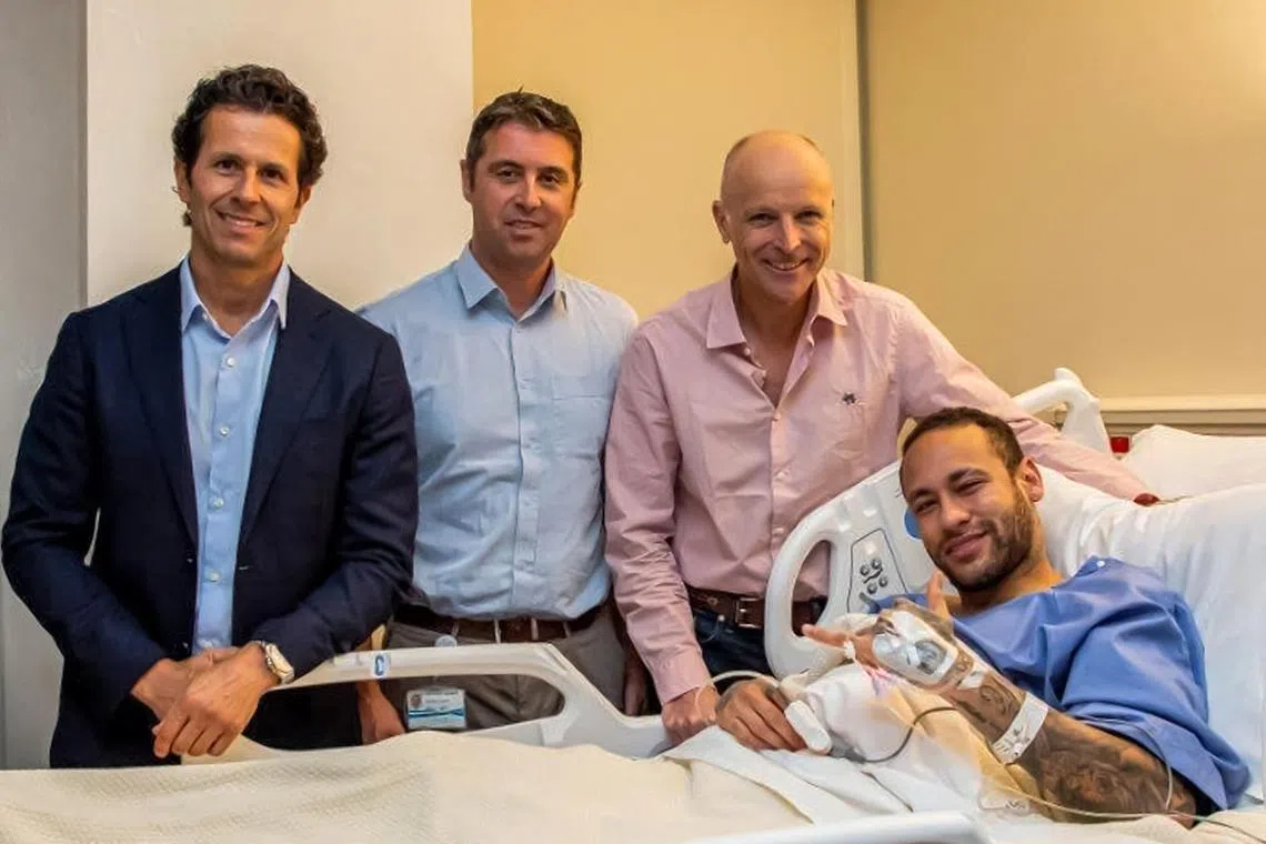 Brazilian football star Neymar is seen after surgery with (from left) Brazilian national team doctor Rodrigo Lasmarchief, Aspetar's chief medical officer Pieter D'Hooghe, and British surgeon James Calder.