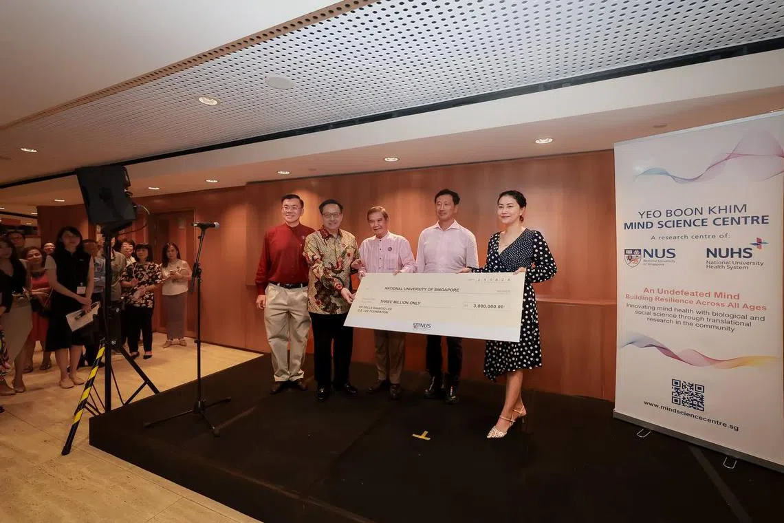 Dr Astrid Suantio presenting a $3-million cheque to (from left) Yeo Boon Khim Mind Science Centre director John Wong Chee Meng, Professor Chong Yap Seng, MSC chairman Abdullah Tarmugi and Health Minister Ong Ye Kung on Aug 25.