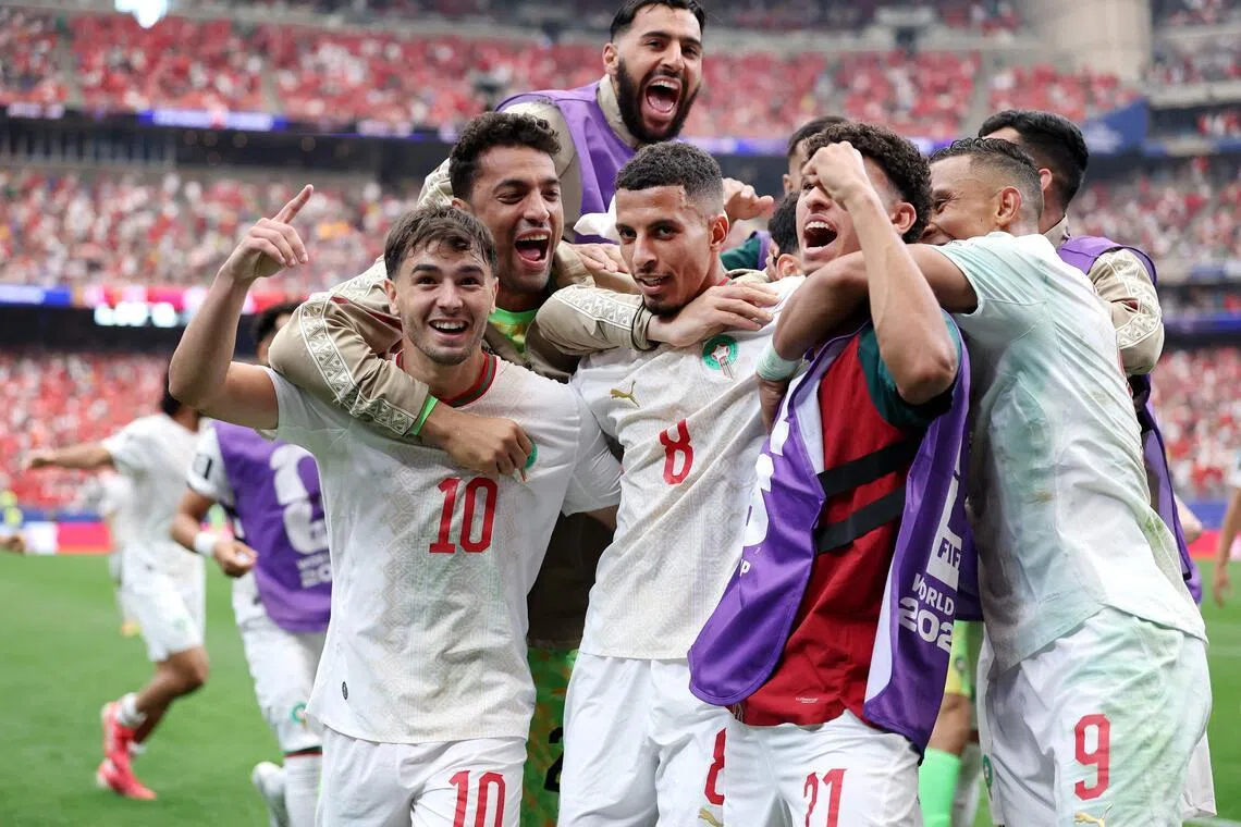 Azzedine Ounahi (No. 8) celebrating with his Morocco teammates after his two-goal performance inspired the African side to a 3-0 World Cup last-16 win over co-hosts Canada on July 4.