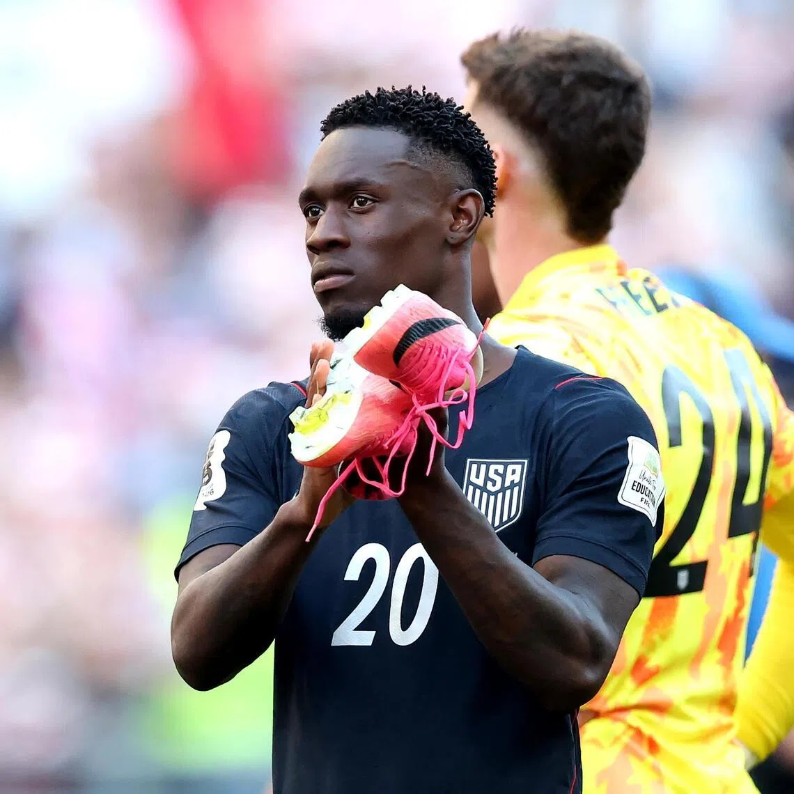 US striker Folarin Balogun applauding fans after their 4-1 loss to Belgium in the World Cup’s last 16 on July 6.