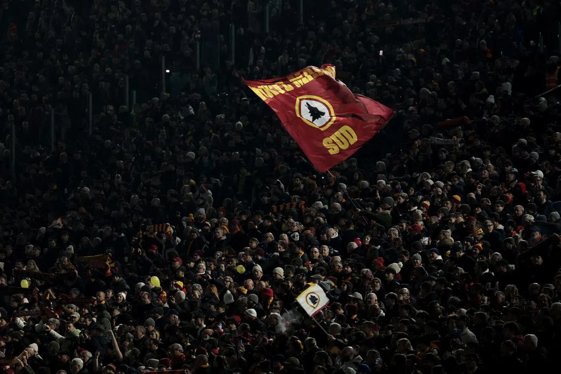 Soccer Football - Serie A - AS Roma v Lazio - Stadio Olimpico, Rome, Italy - January 5, 2025 AS Roma fan displays a flag in the stands before the match REUTERS/Remo Casilli
