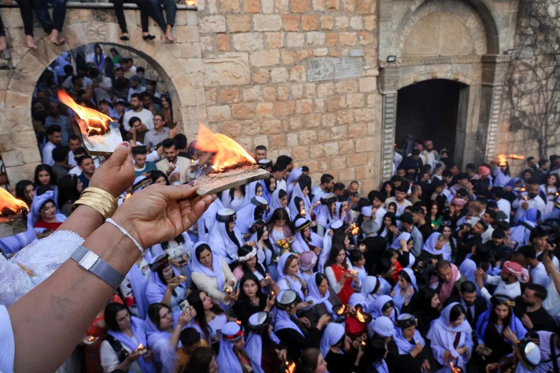 FILE PHOTO: Iraqi Yazidi women light candles on the occasion of Red Wednesday, a ceremony to celebrate the Yazidi New Year at Lalish temple in Shekhan District in Duhok province, Iraq April 16, 2024. REUTERS/Ari Jalal/File Photo