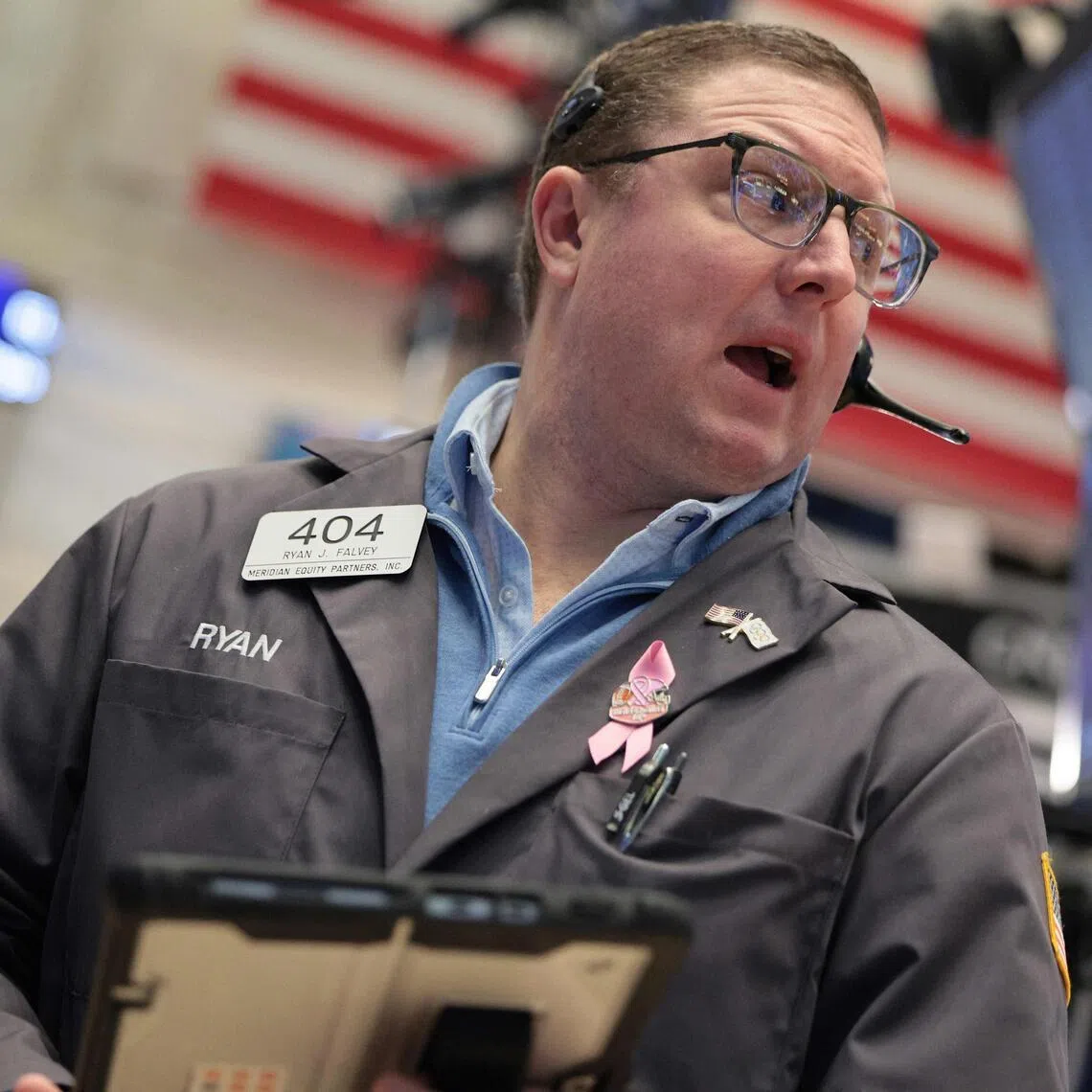 Traders working on the floor of the New York Stock Exchange, during morning trading on March 25, in New York City. 