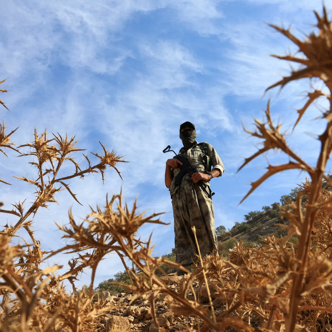 A fighter with the Kurdistan Workers’ Party stands guard in the Qandil mountains, Iraq, on Oct 26, 2025.