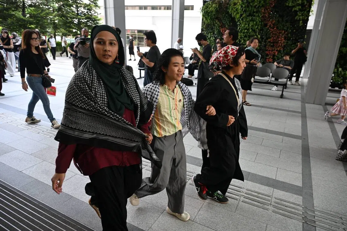 (From left) Dayana Noor Mohamed, Elijah Tay and Amirah Binti Mokhlis arriving at the State Courts on Sept 9.