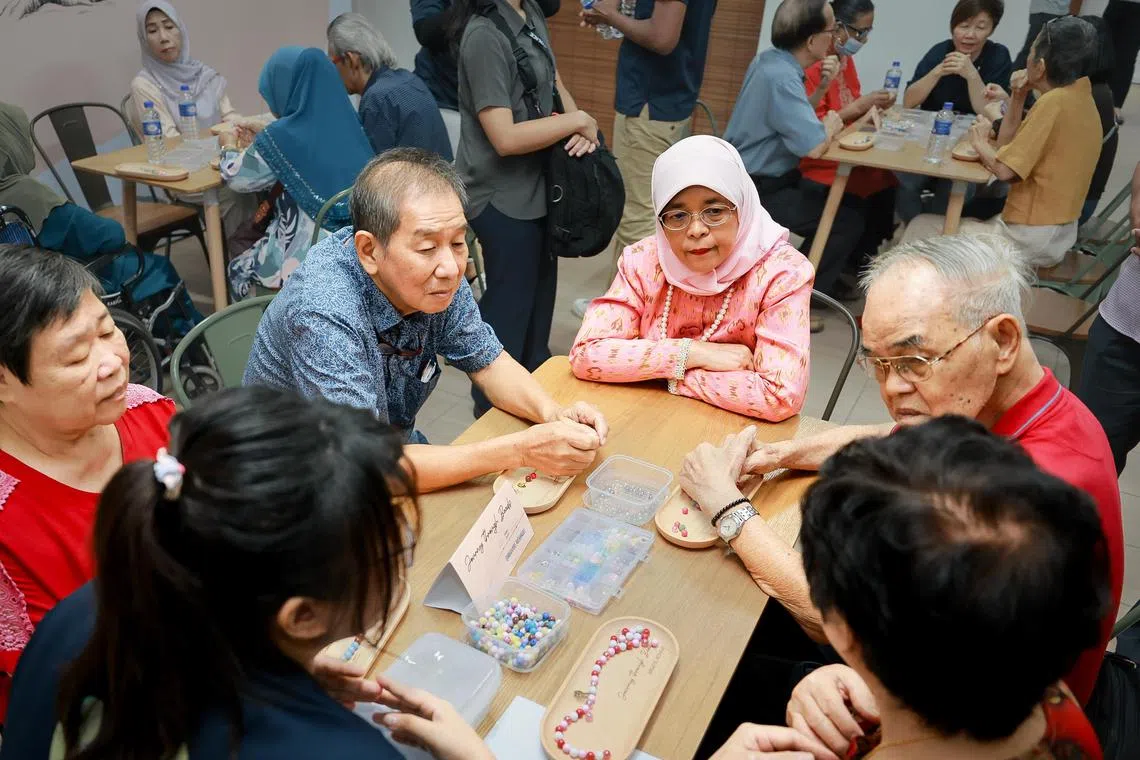 President Halimah Yacob (centre) speaking with Montfort Care caregivers at Montfort Care at Telok Blangah Rise, on Feb 28.