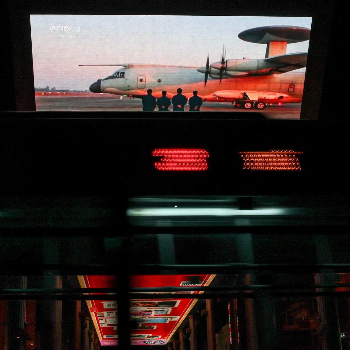 A giant screen showing a news report on China's "Justice Mission 2025" military drills around Taiwan, in Beijing, China, on December 30, 2025.