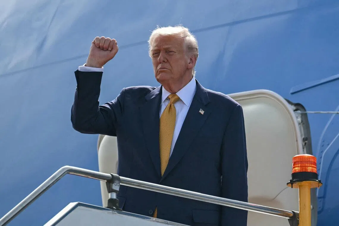 US President Donald Trump gestures as he departs on Air Force One from Kuala Lumpur International Airport in Sepang on Oct 27. He is headed to Japan for the second leg of his Asian tour. 